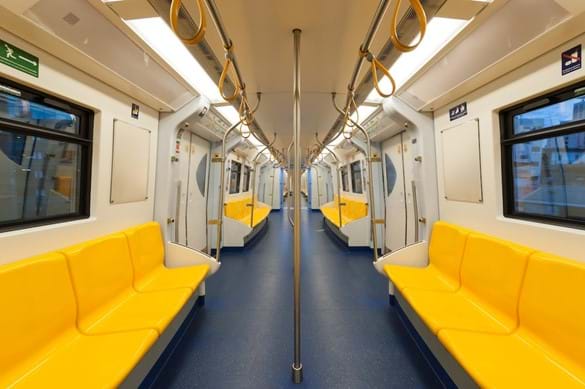 Inside of an empty, modern, train carriage with bright yellow seats