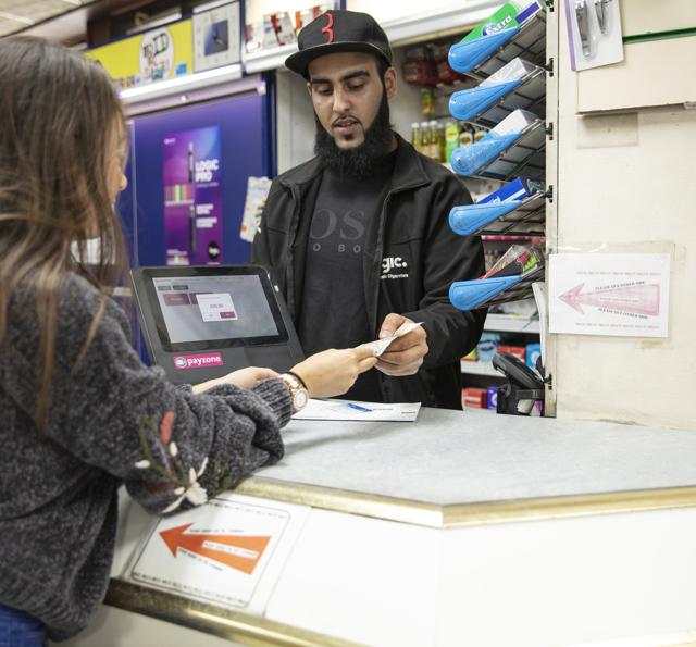 Customer making a cash payment in a retail shop
