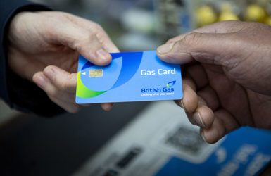 Customer hands British Gas card to a shop worker