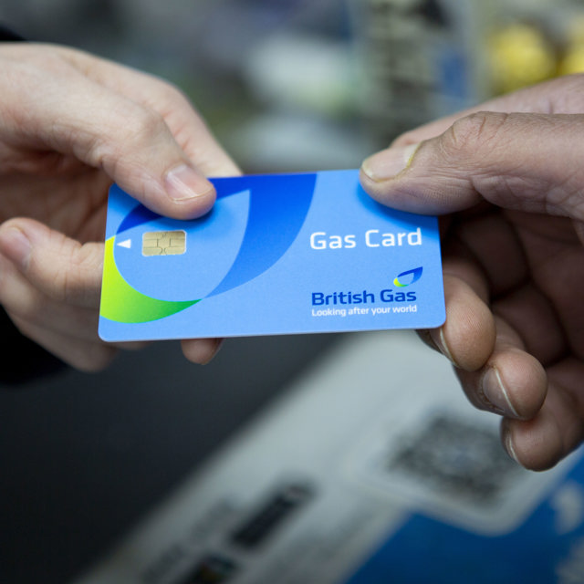 Customer hands British Gas card to a shop worker