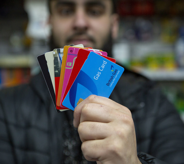 Retailer holding multiple payment cards available via Payzone