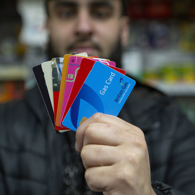 Retailer holding multiple payment cards available via Payzone