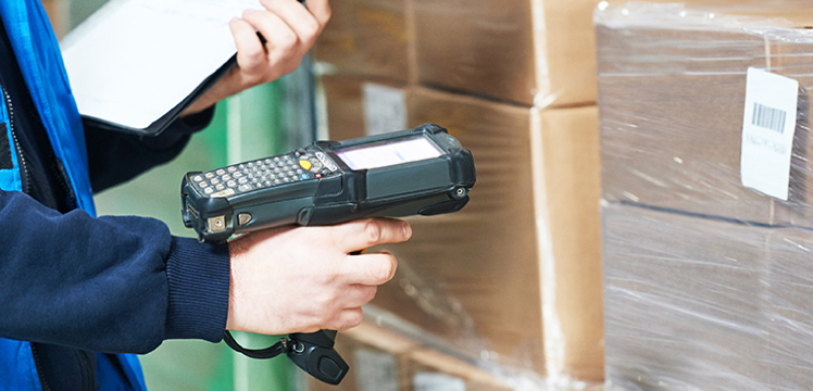 A retail stock assistant scans a box