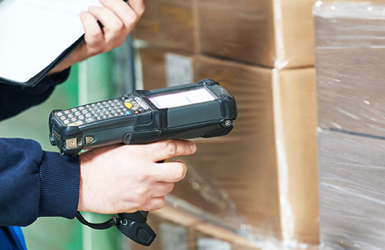 A retail stock assistant scans a box